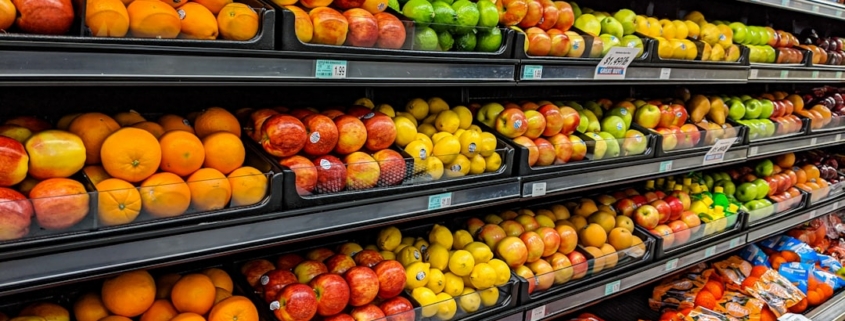 yellow and red apples on black plastic crate